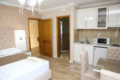 a bedroom with a bed and a kitchen with a table at 