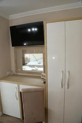 a room with a white cabinet with a flat screen tv at 