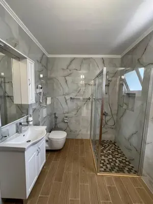 a bathroom with a shower and a toilet and a sink at 