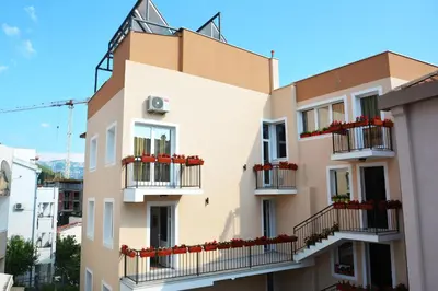 an apartment building with balconies on a city street at Apartments Balabusic in Budva
