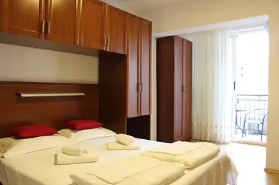 a bedroom with two beds with towels on them at Apartments Balabusic in Budva