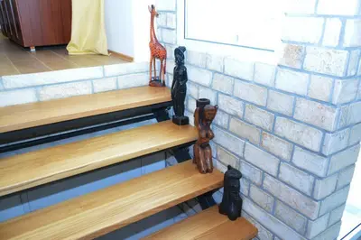 a set of stairs with giraffe figurines next to a brick wall at Apartments Balabusic in Budva