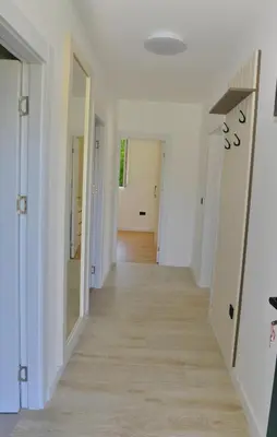 a hallway of a house with white walls and wood floors at Villa Jovanovic in Tivat