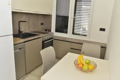 a kitchen with a bowl of fruit on a table at Villa Jovanovic in Tivat