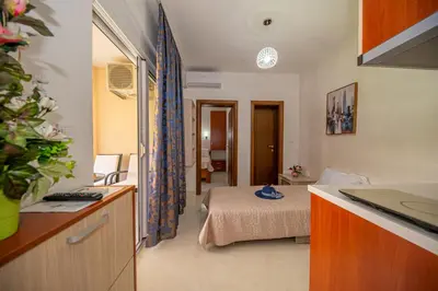 a hotel room with a bed and a bathroom at Kristal Apartmani in Čanj