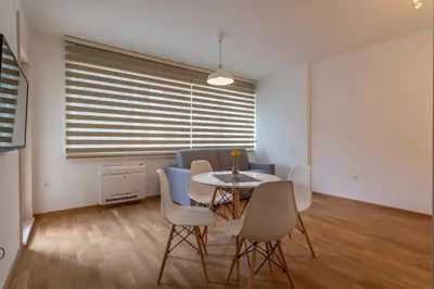 a dining room with a table and chairs at Lungomare Lux Apartments in Budva