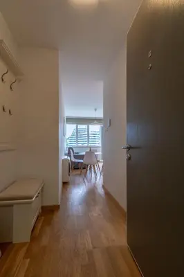 a room with a door and a dining room with a table at Lungomare Lux Apartments in Budva