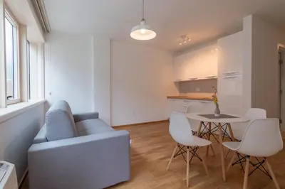 a living room with a blue couch and a table at Lungomare Lux Apartments in Budva