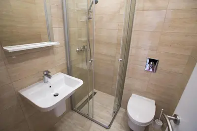 a bathroom with a shower and a sink and a toilet at Villa SAN Apartments in Tivat