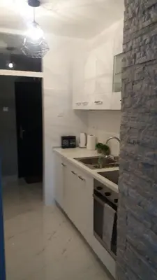 a white kitchen with a sink and a stove at Holiday Home Duka's in Bar