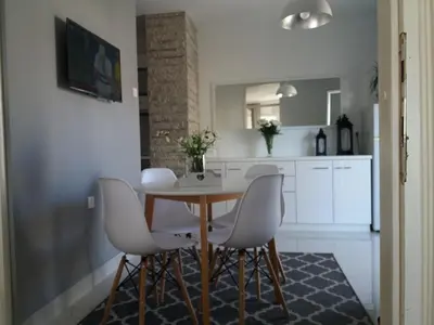 a kitchen and dining room with a table and chairs at Holiday Home Duka's in Bar