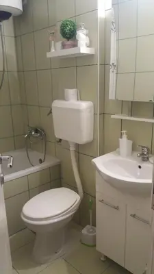 a bathroom with a toilet and a sink at Holiday Home Duka's in Bar