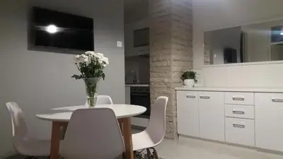 a kitchen with a table with a vase of flowers on it at Holiday Home Duka's in Bar