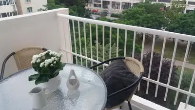 a glass table with a vase of flowers on a balcony at Holiday Home Duka's in Bar