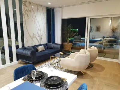 a living room with a blue couch and chairs at Villa Preciosa in Kotor
