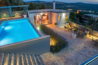 a villa with a swimming pool at night at Villa Preciosa in Kotor
