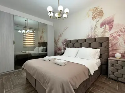 a bedroom with a large bed and a large mirror at Villa Preciosa in Kotor