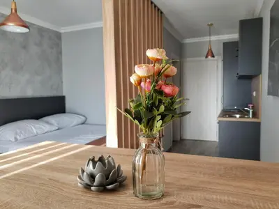 a vase of flowers on a table in a room at Villa Preciosa in Kotor