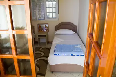 a small bedroom with a bed in a room at Apartments Lux seaview in Bar
