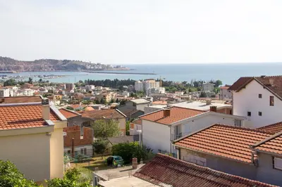 a view of a city with houses and the ocean at Apartments Lux seaview in Bar