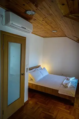 a bedroom with a bed with a wooden ceiling at Markov konak in Cetinje