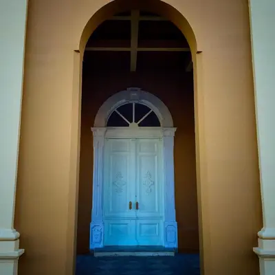 an archway with a blue door in a building at Markov konak in Cetinje