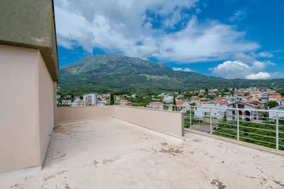 a balcony with a view of a mountain at 1bd Modern Apt in Dobra Voda with Roof Access 