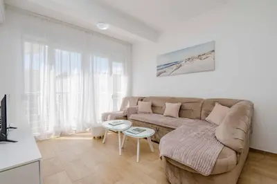 a living room with a couch and a table at 1bd Modern Apt in Dobra Voda with Roof Access 