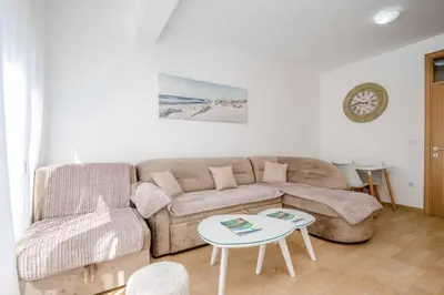 a living room with a couch and a table at 1bd Modern Apt in Dobra Voda with Roof Access 