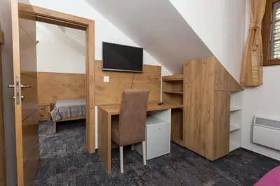 a room with a desk and a tv on a wall at Tilia in Cetinje