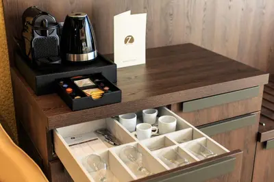 a drawer with cups and a coffee maker on a desk at Hotel Zeta in Budva