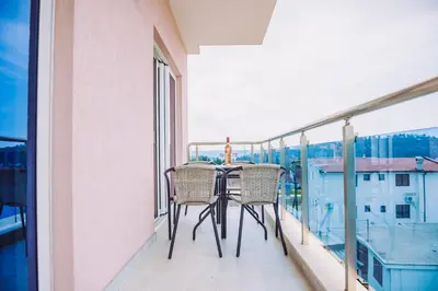 a balcony with a table and chairs on a balcony at Apartments Krstovic in Sutomore
