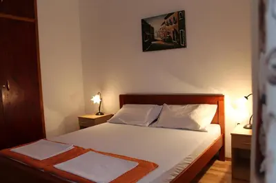 a bedroom with a bed with two towels on it at Apartman Bošković in Budva