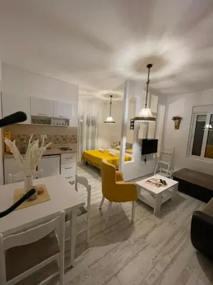 a living room with a kitchen and a bedroom at Apartments Tina in Utjeha