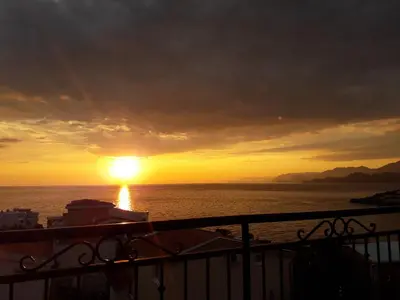 a sunset from a cruise ship in the ocean at Apartments Tina in Utjeha
