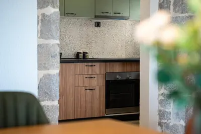 a kitchen with wooden cabinets and an oven at Villa Gorazda in Kotor