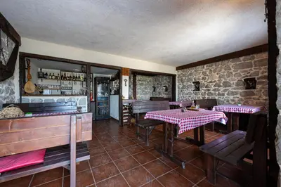 a restaurant with tables and benches in a room at Villa Gorazda in Kotor