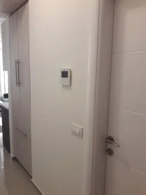 a door in a room with a hallway with cabinets at Apartman Nina in Bar