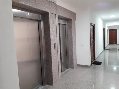 a hallway with two elevator doors in a building at Apartman Nina in Bar