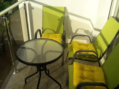 a balcony with a table and chairs on a balcony at Apartman Nina in Bar