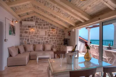 a living room with a couch and a table at Piazza Apartments 1 in Petrovac na Moru