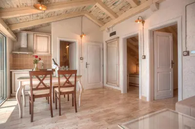 a kitchen and dining room with a table and chairs at Piazza Apartments 1 in Petrovac na Moru