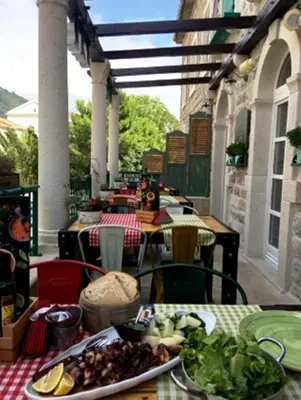 a plate of food on a table on a patio at Piazza Apartments 1 in Petrovac na Moru