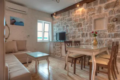 a living room with a couch and a table in a room at Piazza Apartments 1 in Petrovac na Moru