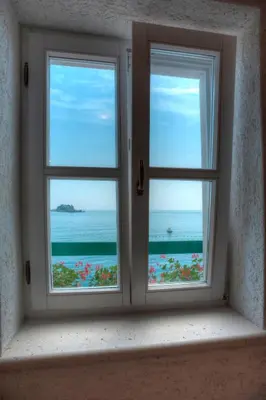 an open window with a view of the ocean at Piazza Apartments 1 in Petrovac na Moru