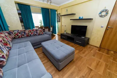a living room with a couch and a flat screen tv at Hotel Obala in Budva