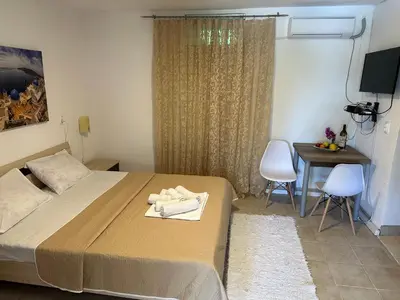 a bedroom with a bed and a table with chairs at Andolly Apartments in Bar