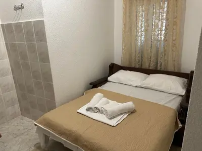 a bedroom with a bed with towels on it at Andolly Apartments in Bar
