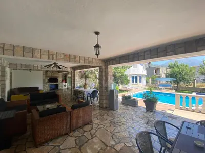 a living room with a swimming pool and a patio at Andolly Apartments in Bar