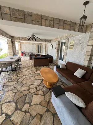 a living room with a couch and a table at Andolly Apartments in Bar